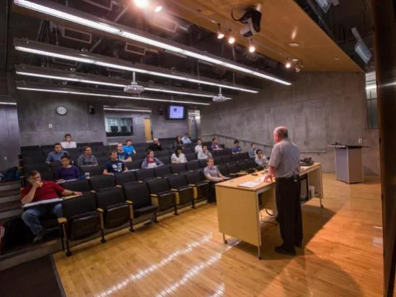 Lecturer giving a presentation to 20 individuals